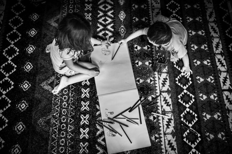 children playing on a rug, drawing